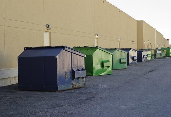 large construction waste containers in a row at a job site in Spring Grove